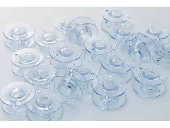 Bobbins, clear plastic, 10-pack, 3/8 size